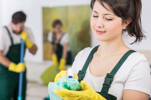 Technician performing commercial carpet cleaning in a business setting